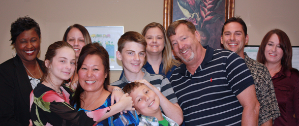 With the help of Brevard Family Partnership and IMPOWER, Cory (second row, center) and his sister Angelina (left) were adopted in 2014 and became part of the Bodenheimer “forever family.” 